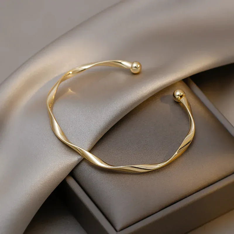 Golden Charm Bangle – Minimalist Twisted Cuff Bracelet for Women