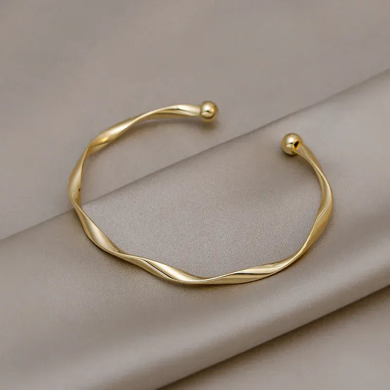 Golden Charm Bangle – Minimalist Twisted Cuff Bracelet for Women